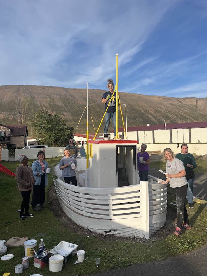 Sjálfboðaliðar að mála bátinn Ágústu á Sumarróló á Suðureyri.