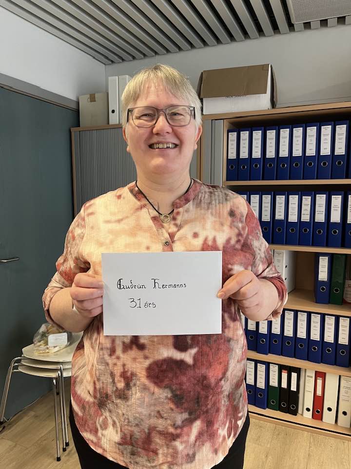 Guðrún á launadeildinni brosandi með umslag sem á stendur Guðrún Hermanns, 31 ár.