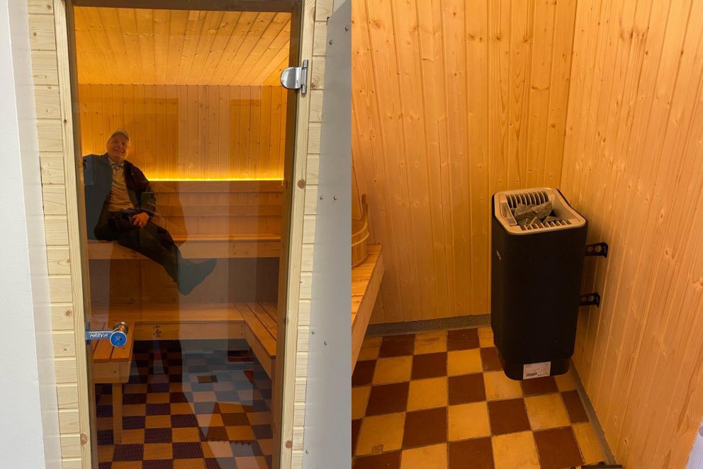 Grétar Helgason, forstöðumaður, stillir sér upp í klefanum. Hægra megin er nýi ofninn.